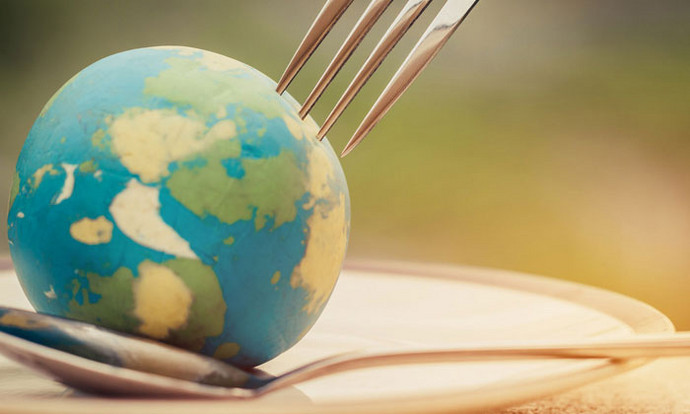 Nachhaltige Ernährung: Ein Symbolbild mit Weltkugel sowie Gabel und Löffel.